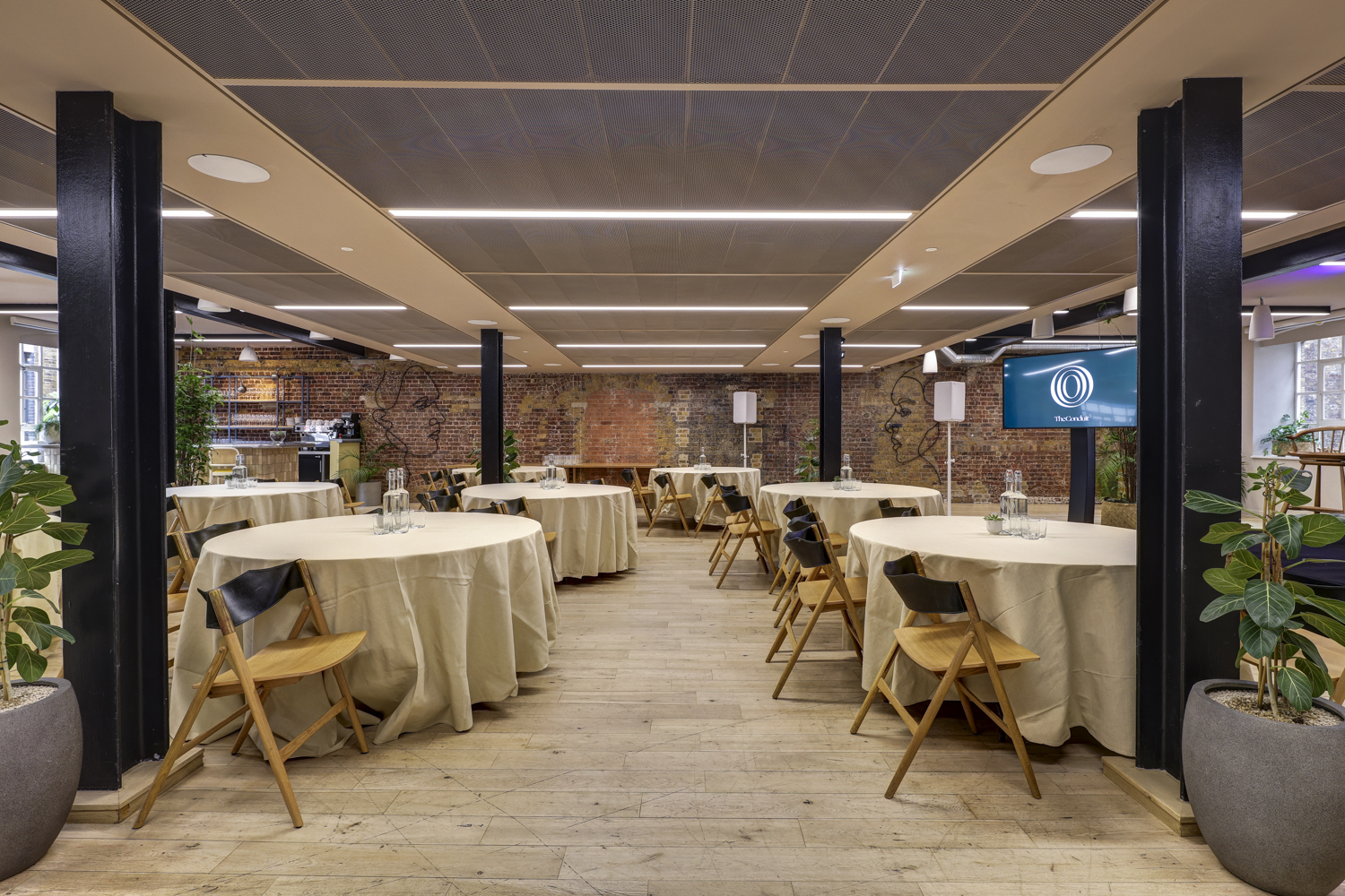 The Forum in The Conduit: modern event space with round tables for meetings and gatherings. - Banner