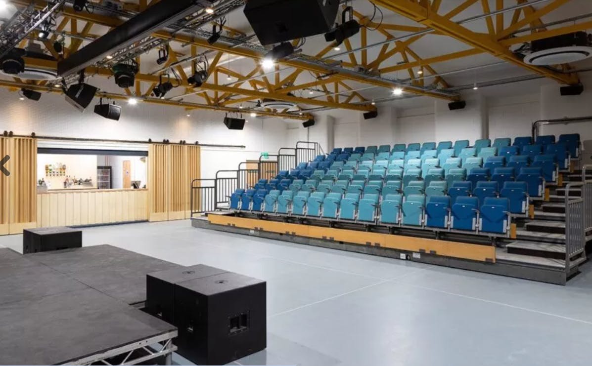 Versatile event space with tiered seating for presentations and performances in The Vale.