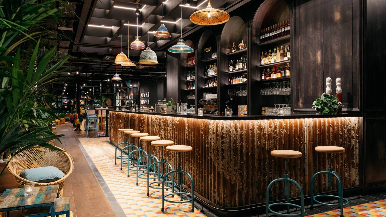 Stylish bar at Ruby Zoe Hotel, perfect for networking events and cocktail receptions. - Banner