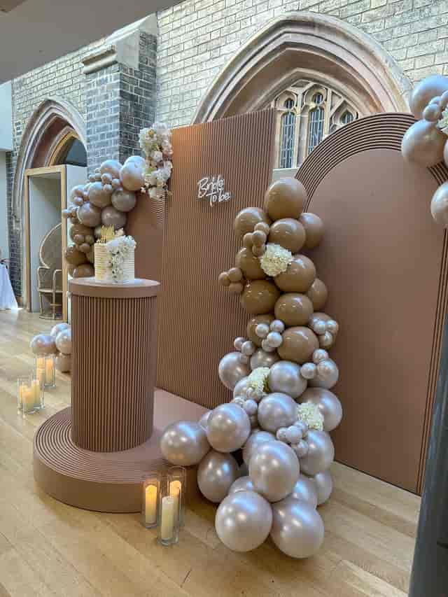 Elegant balloon backdrop for weddings and milestone events in soft neutral tones.