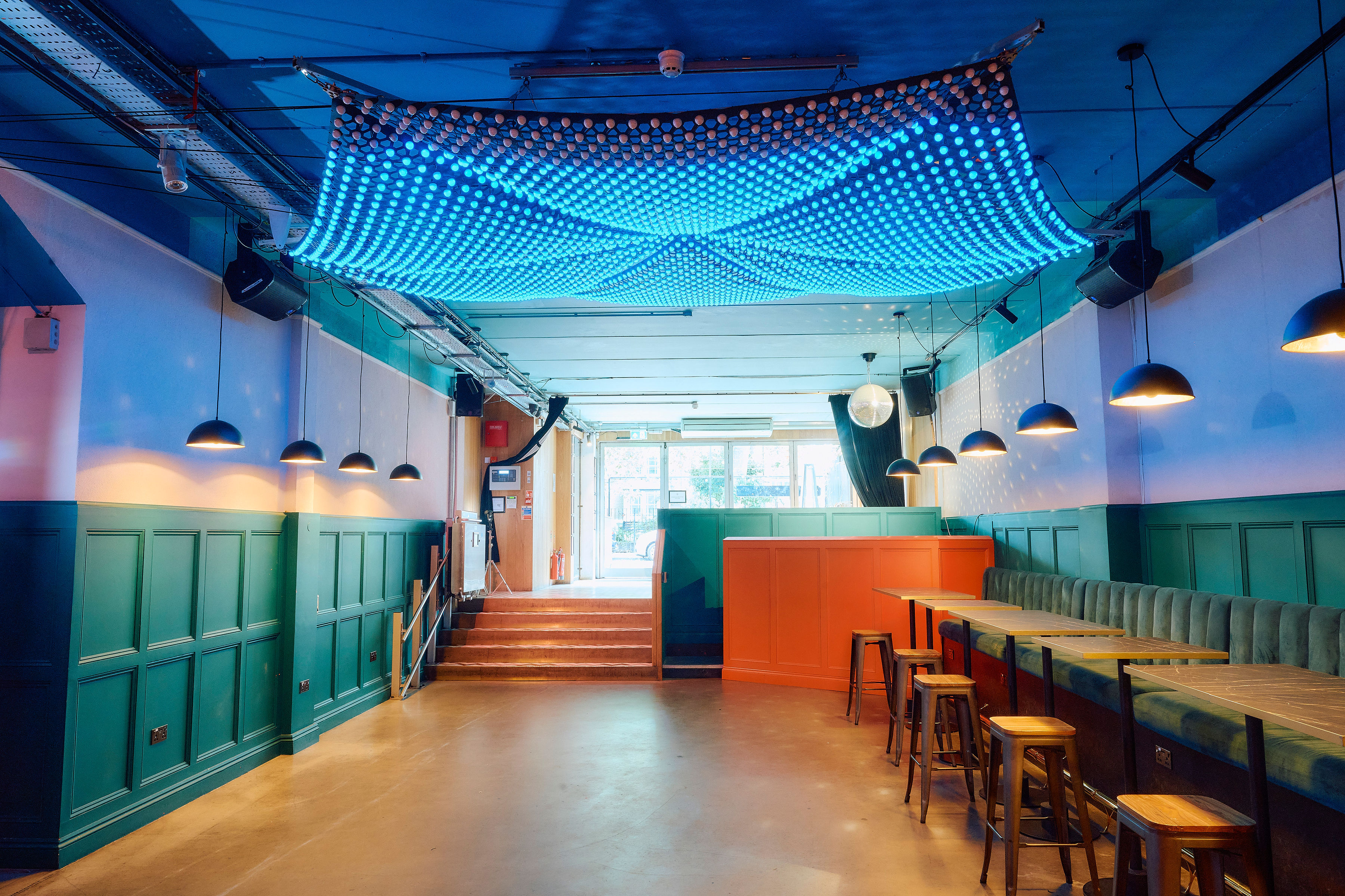 Main Bar & Terrace at Colours Hoxton, modern event space with blue lighting, ideal for gatherings. - Banner