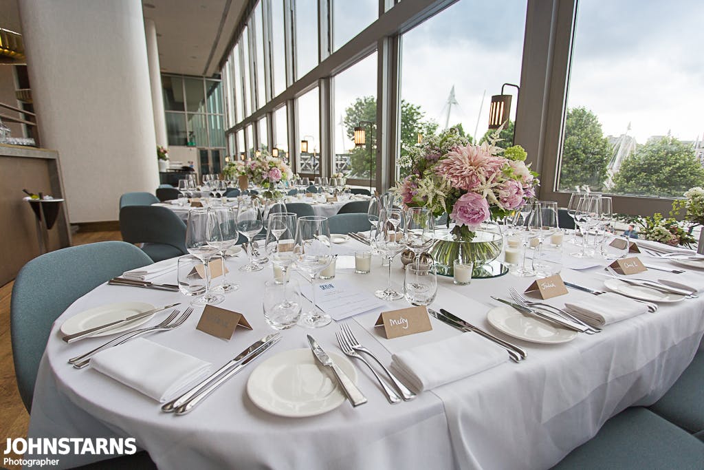 Elegant dining table with floral centerpieces for corporate events and galas.