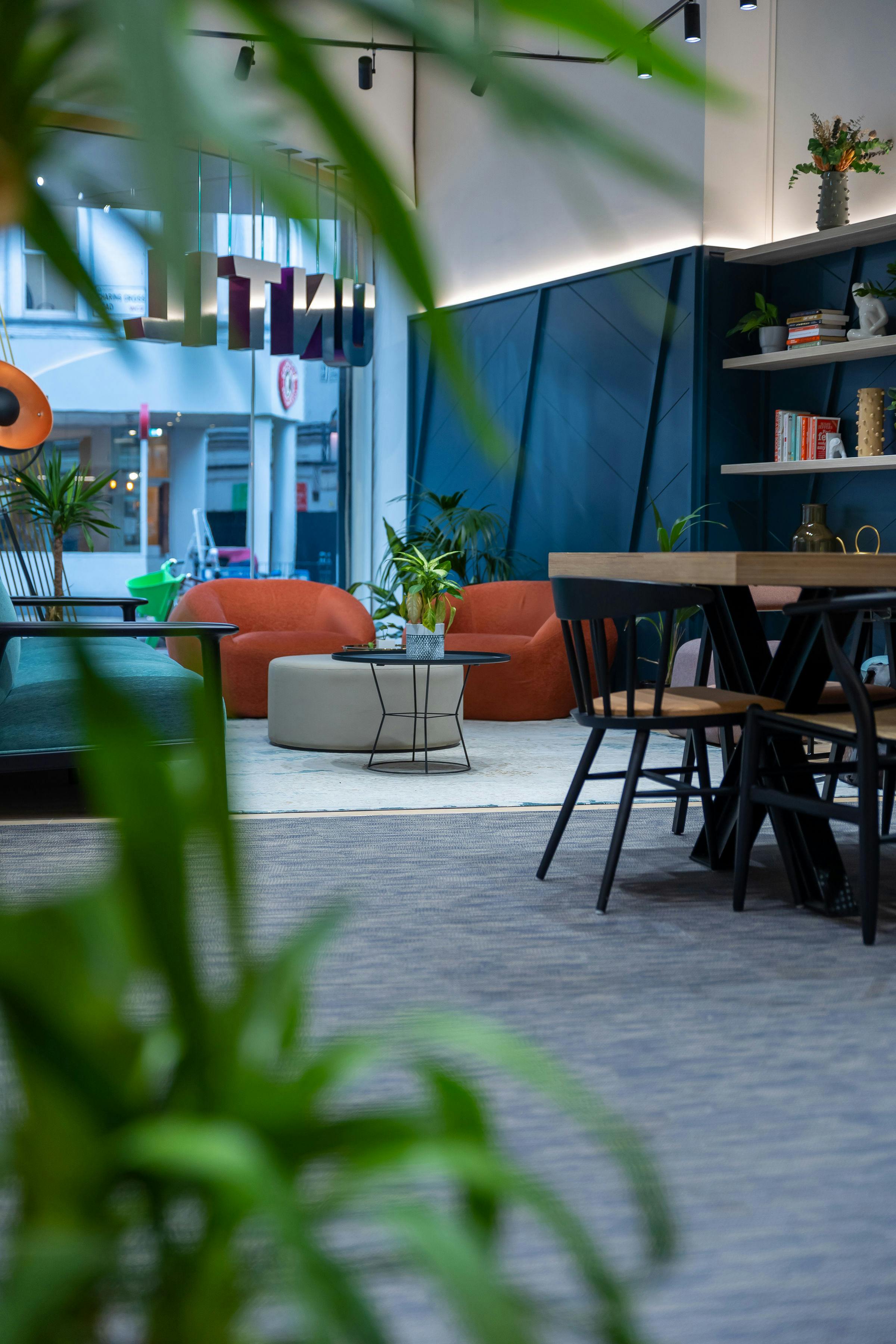 Modern meeting space in UNTIL Soho with greenery for collaboration and creativity.