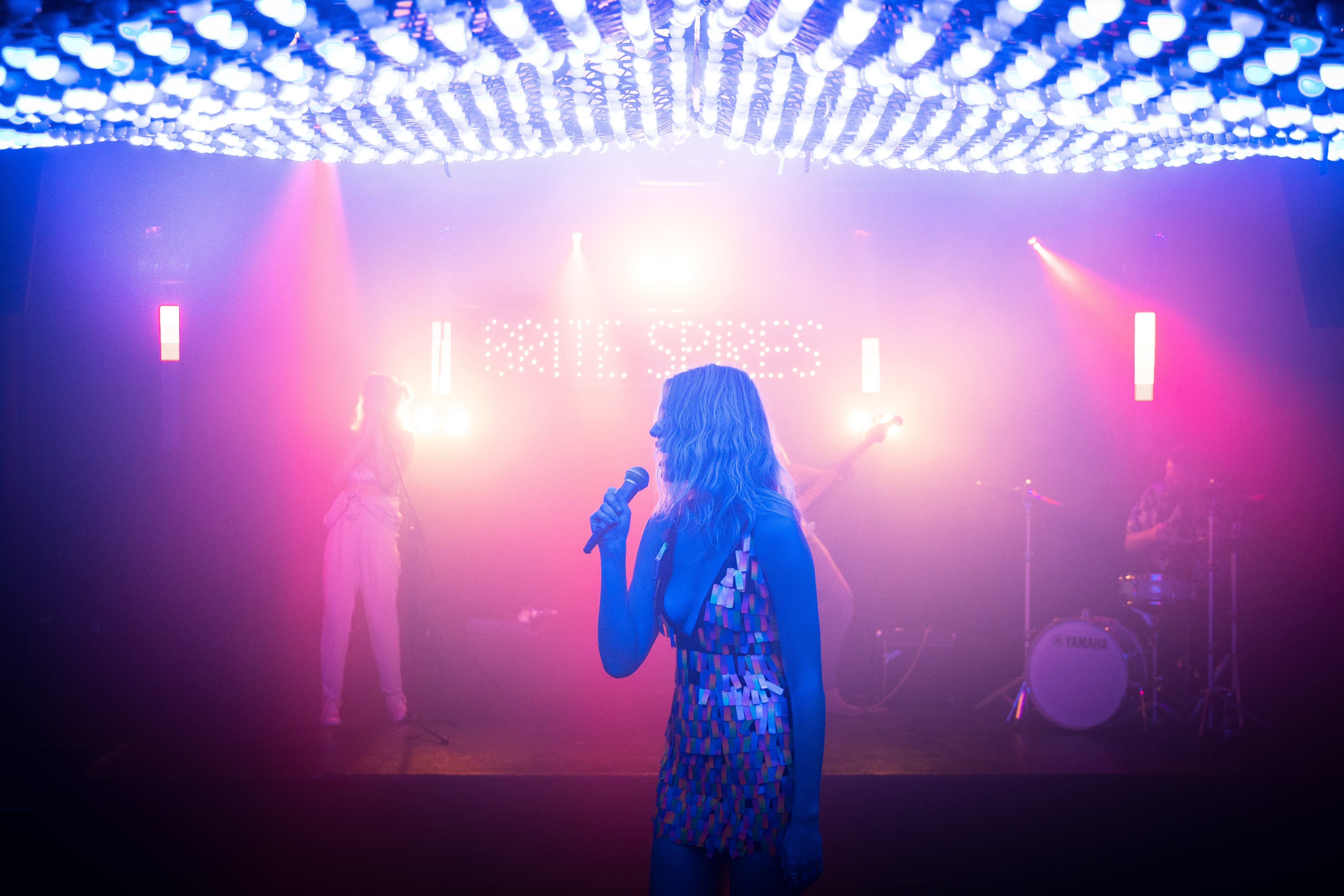 Vibrant live performance at Colours Hoxton with dynamic lighting and engaging entertainment. - Banner