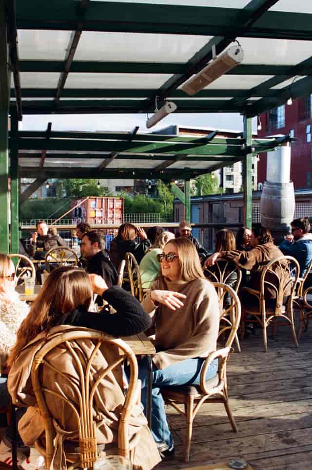 Vibrant outdoor networking event at Hackney Wick with relaxed seating and natural light.