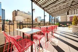 Vibrant rooftop venue with pink seating, perfect for networking events and receptions.