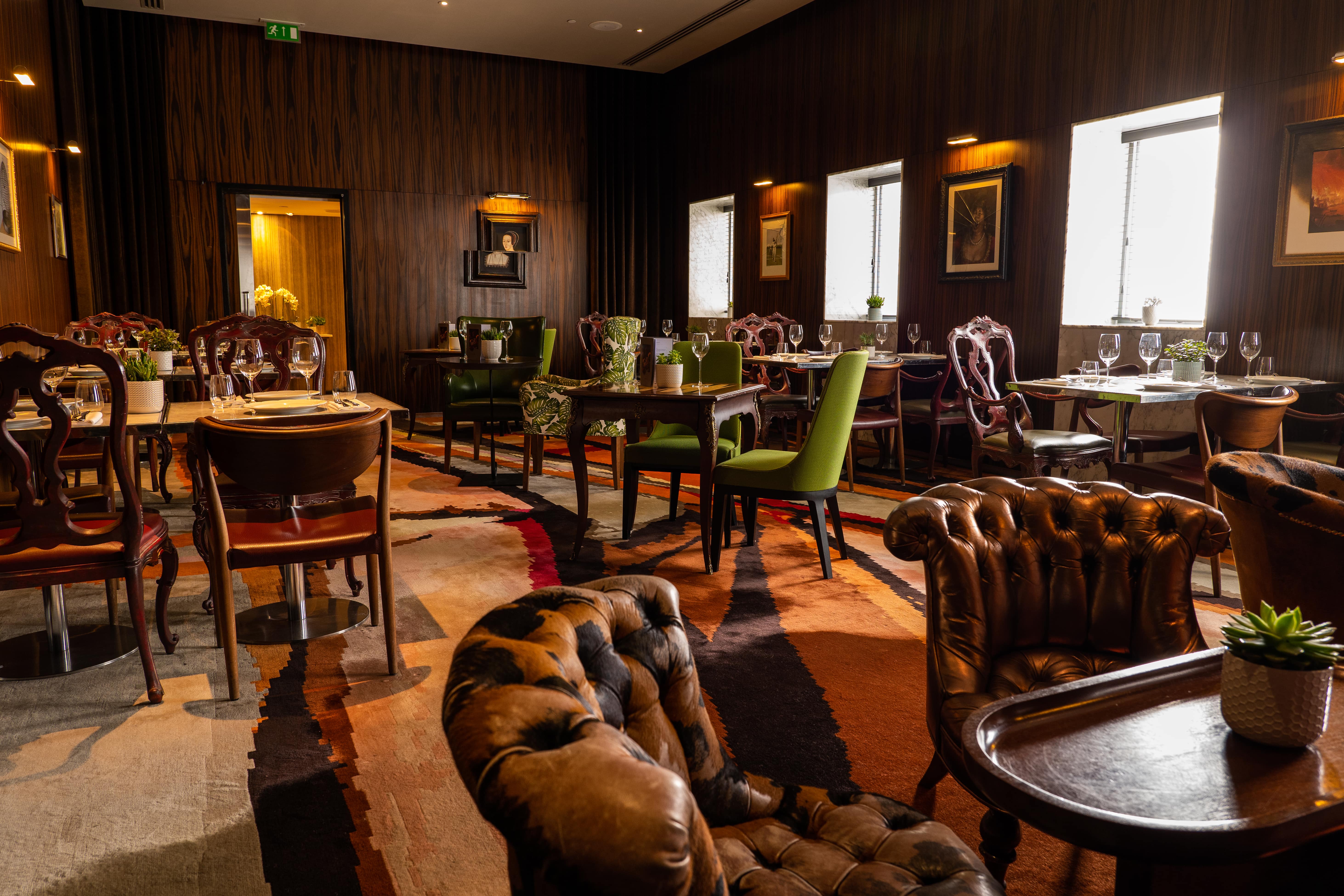 Elegant dining space at The Den, ideal for intimate meetings and events. - Banner