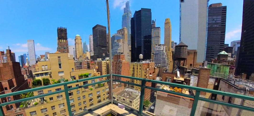 Rooftop terrace with urban skyline, perfect for networking events and cocktail parties.