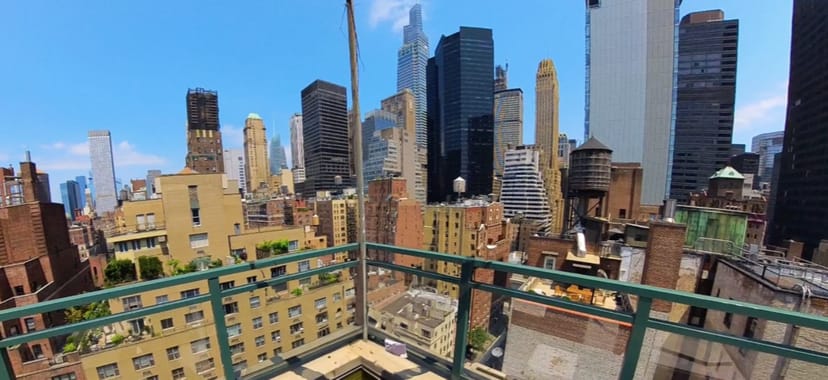 Rooftop terrace with urban skyline, perfect for networking events and cocktail parties.