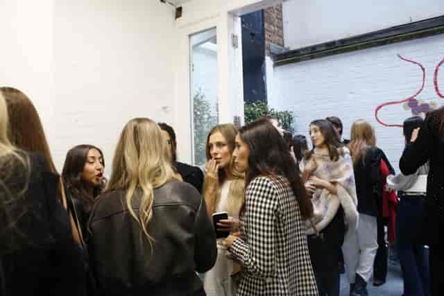 Vibrant networking event in Fitzrovia Gallery with stylish attendees and natural light.