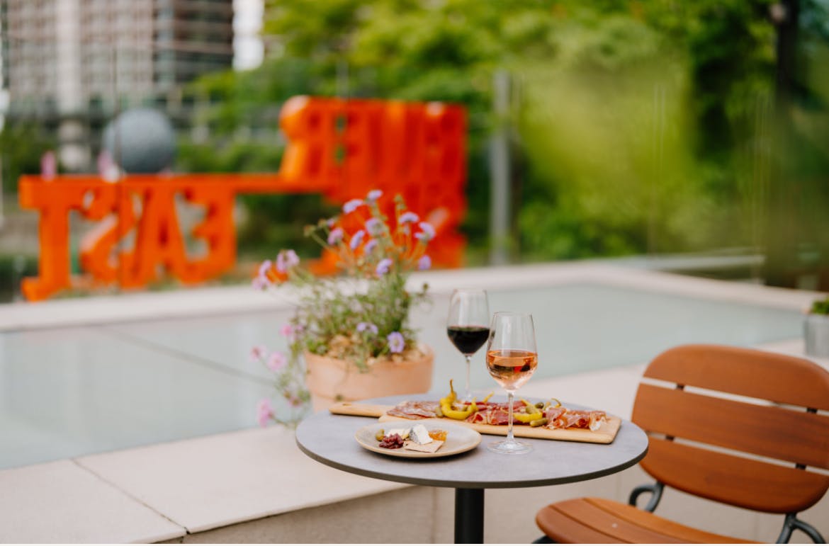 Stylish outdoor networking venue with gourmet appetizers and wine in Riverside East.