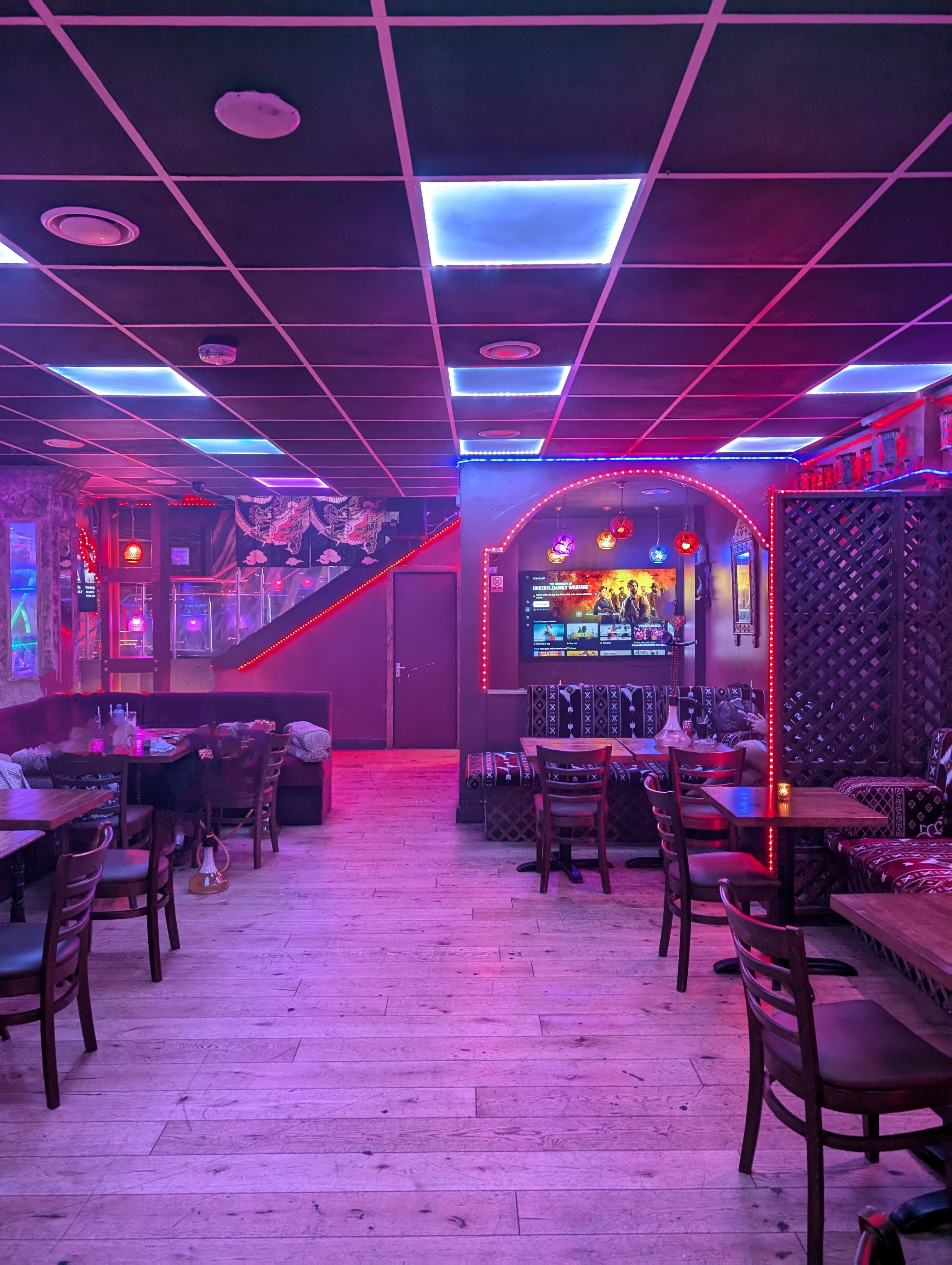Vibrant Dream Lounge private section with neon lighting for themed parties and gatherings.