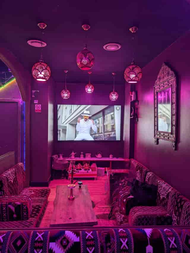 Vibrant Dream Lounge event space with large screen, ideal for networking and gatherings.