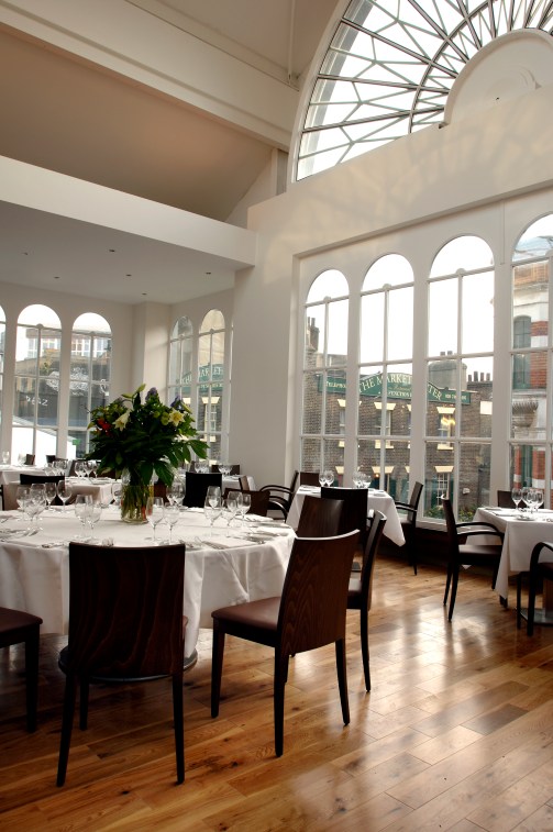 Elegant Floral Hall dining setup with round tables for upscale events and meetings. - Banner