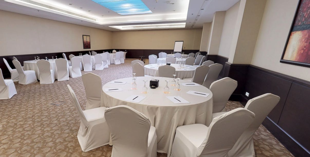 Meeting space with round tables in Courtyard Riyadh for workshops and conferences.