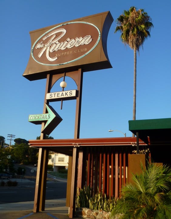 Turquoise Room sign at Riviera Supper Club, ideal for casual networking events and gatherings.