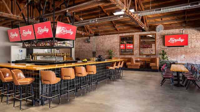 Stylish Brick by Brick lounge with modern bar, ideal for corporate events and gatherings.
