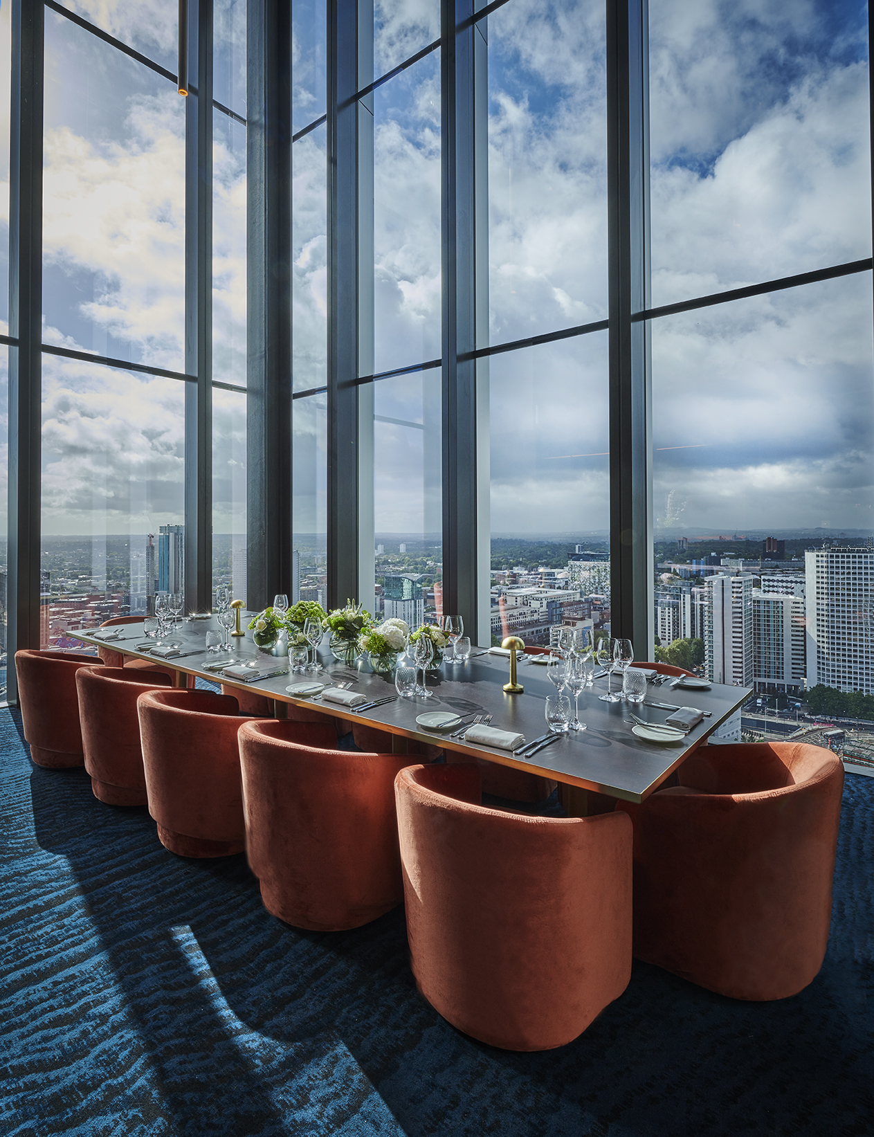 Elegant dining setup in Orelle venue with panoramic city view for corporate events. - Banner