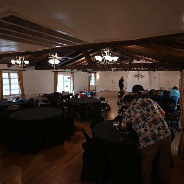Large indoor banquet hall with rustic charm, ideal for events and gatherings.
