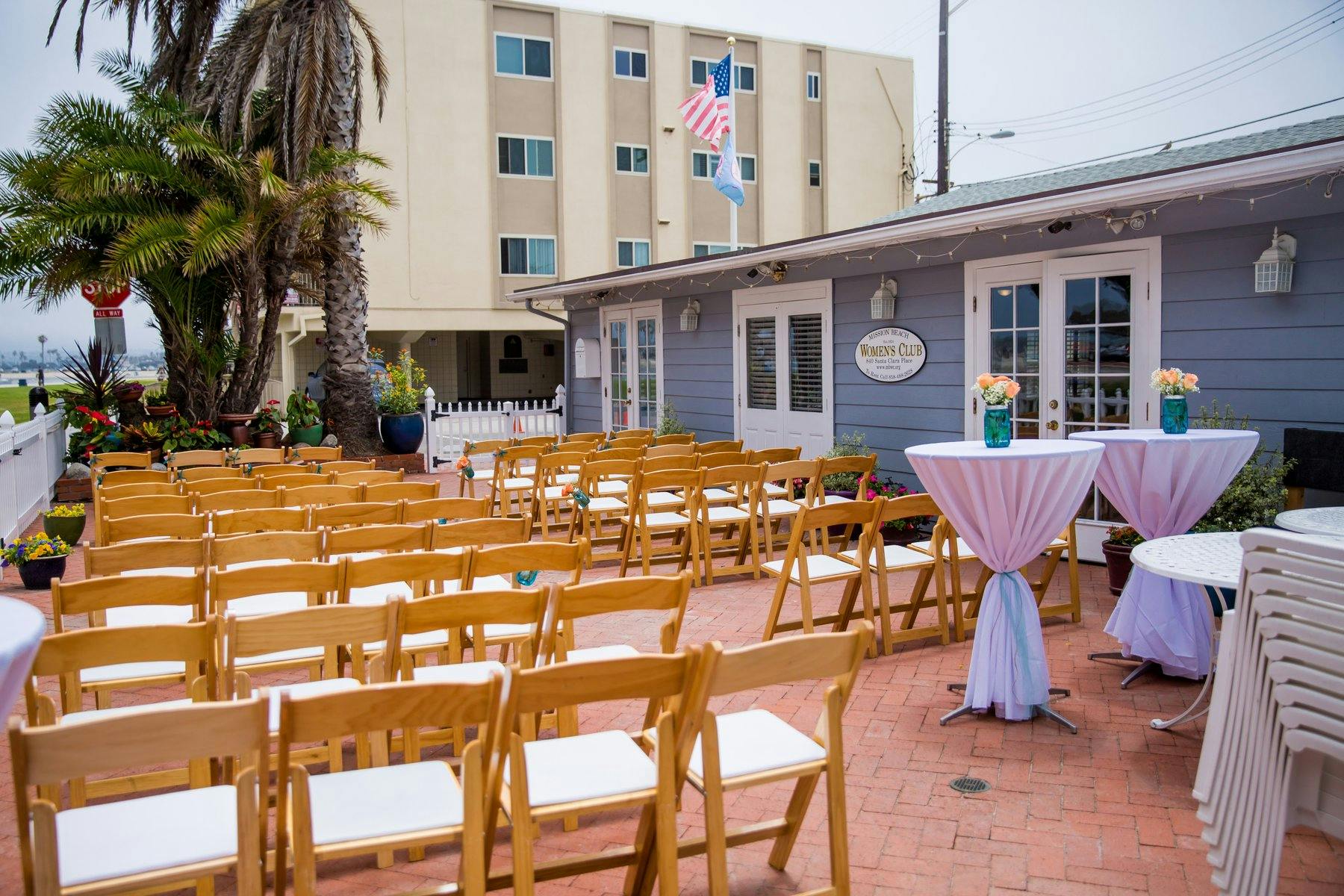 Bayside garden patio with wooden chairs, ideal for outdoor events and gatherings.