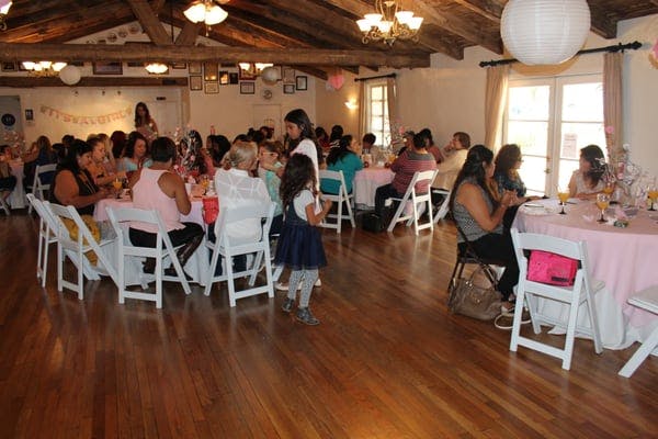 Business office event space with rustic beams, ideal for family-friendly gatherings.