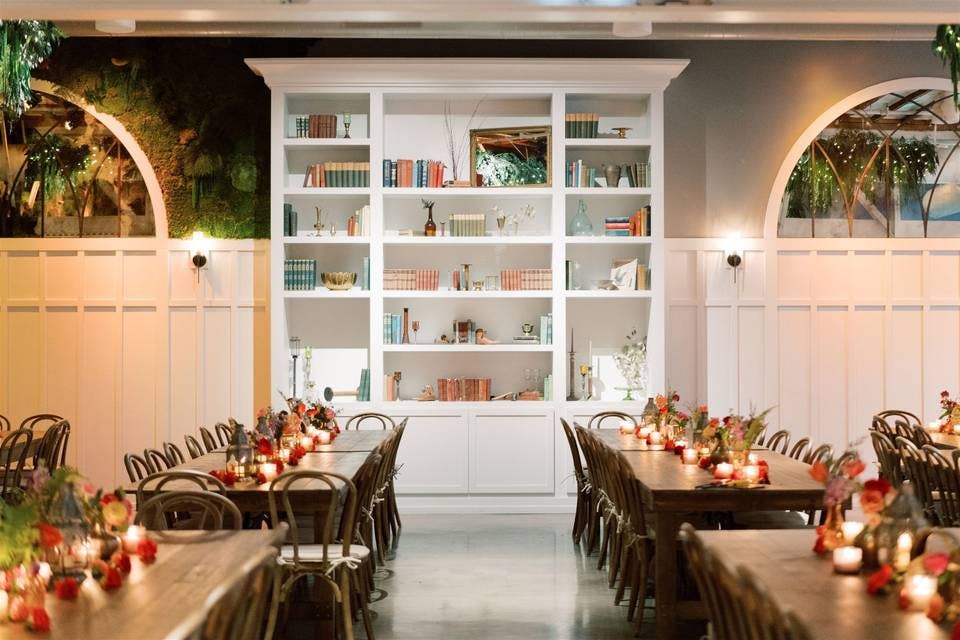 Elegant dinner setup in Flora's Bookcase Room, perfect for intimate gatherings and events.