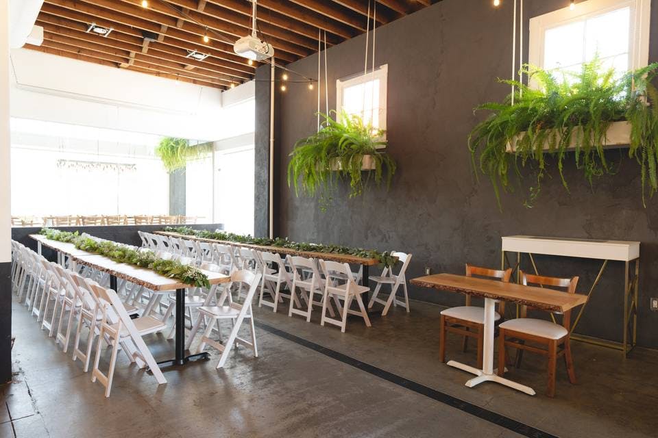 Kombuchery event space with long tables, ideal for networking and workshops.