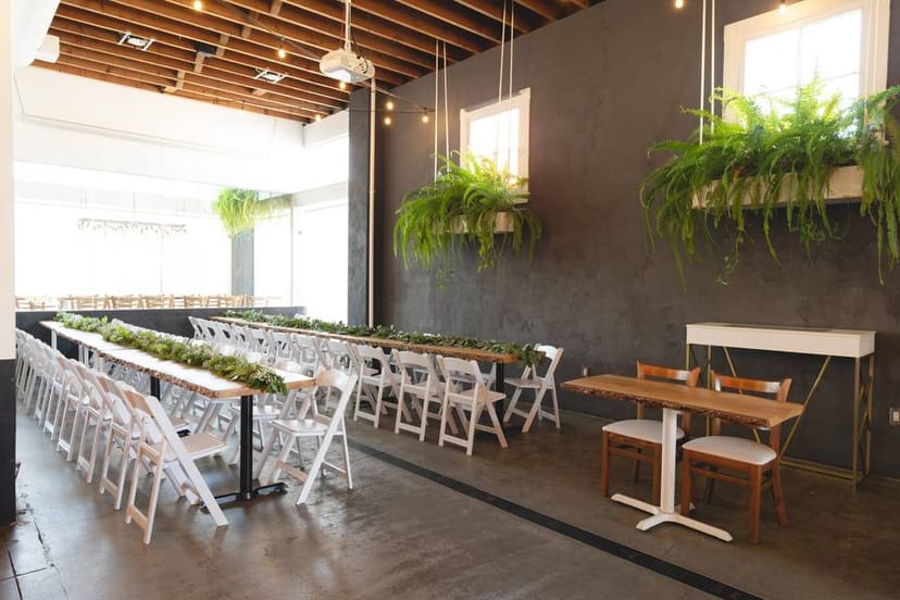 Kombuchery event space with long tables, ideal for networking and workshops.