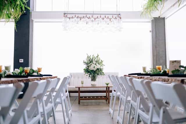 Elegant event space at Kombuchery with floral centerpiece, perfect for gatherings and meetings.