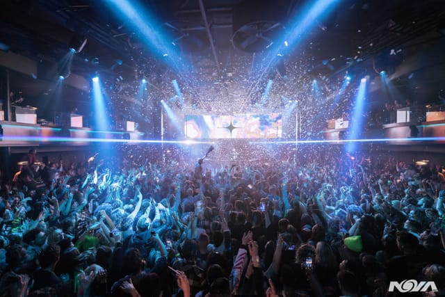 Vibrant crowd at NOVA SD event with dynamic lighting and confetti celebration.