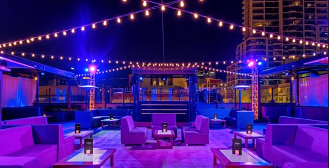 Rooftop event space with string lights, ideal for networking and social gatherings.