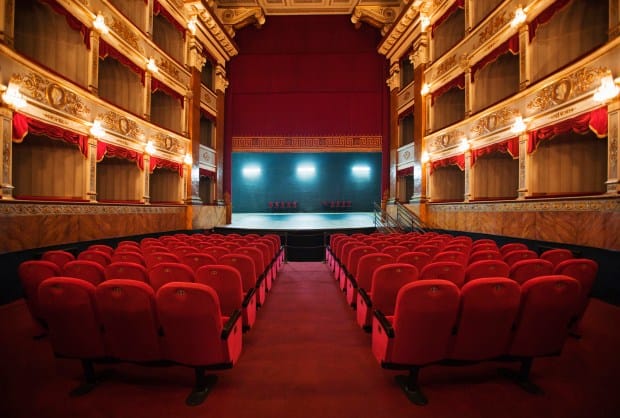 Moxie Theatre stage with plush red seating, ideal for performances and conferences.