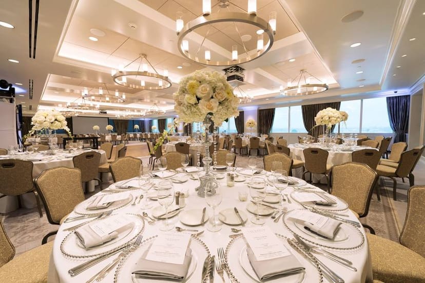 Elegant banquet hall with white linens, perfect for weddings and corporate events.