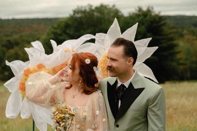 Couple in floral attire at whimsical outdoor wedding, perfect for photography services.