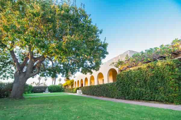 Serene outdoor venue with lush greenery for events at Ocean Beach Woman's Club.