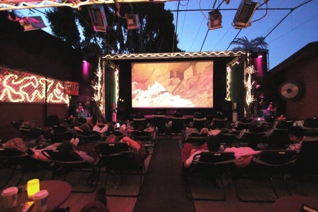 Outdoor cinema Cabana love booth with cozy lounge chairs for unique events.