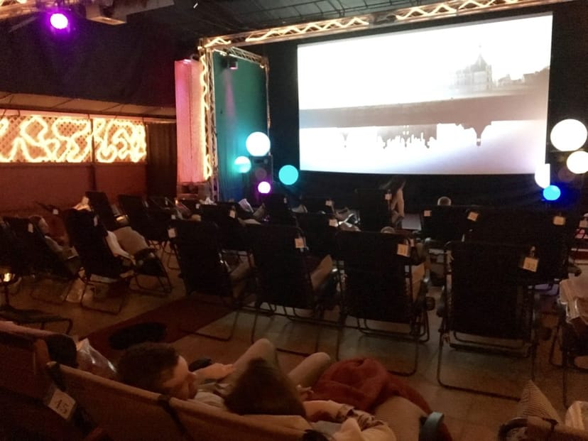 Cozy Cabana love booth with reclining chairs for intimate film screenings under the stars.