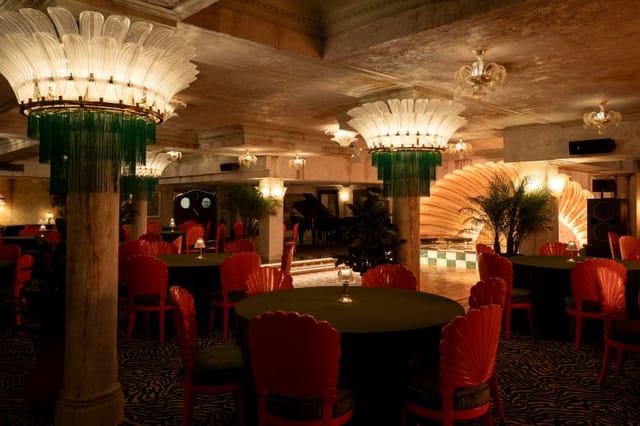 Lou Lou's Jungle Room: elegant event space with vibrant red chairs for gatherings.