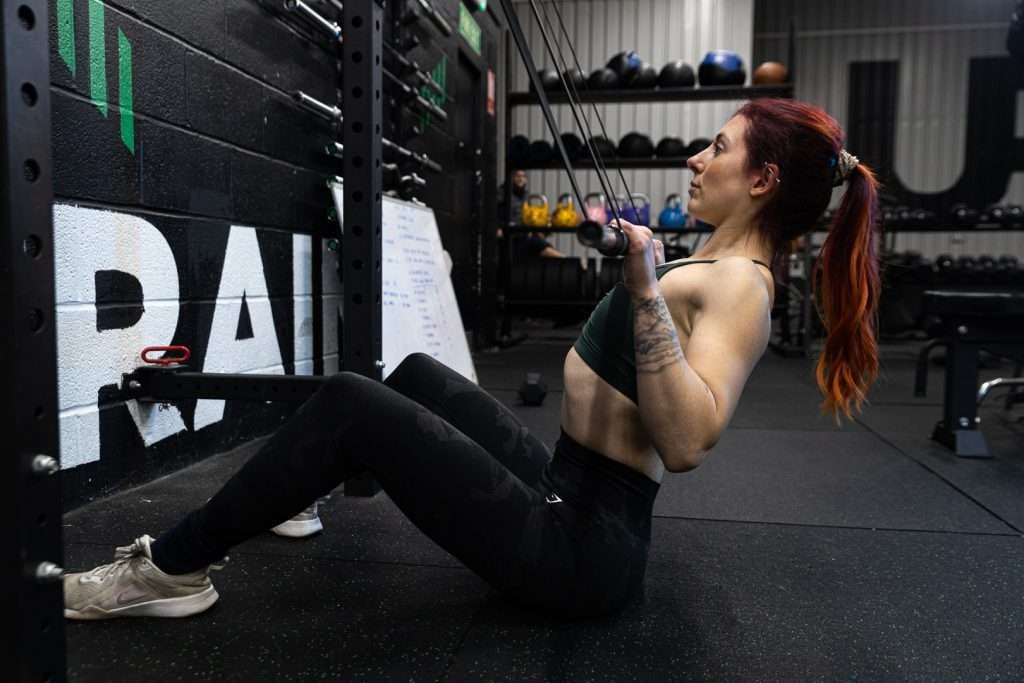 Fitness enthusiast doing resistance training in Private Studio for wellness event.