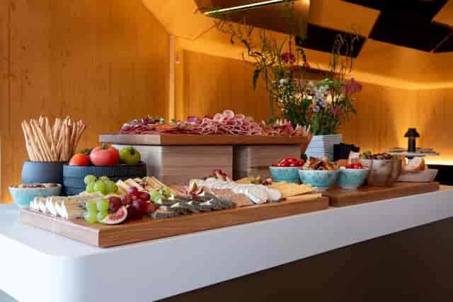 Elegant cheese and charcuterie display at Oceanbird Lounge, ABBA Voyage event catering.