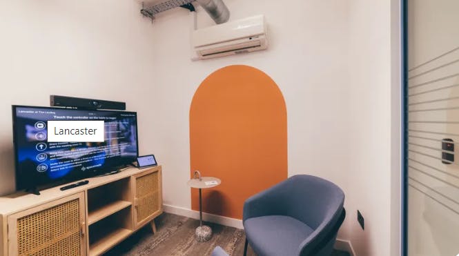 Modern meeting space in Lancaster with sleek TV, ideal for brainstorming sessions.