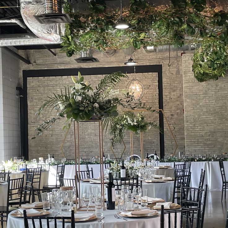 Elegant event space with tall floral centerpieces, perfect for weddings and upscale gatherings.