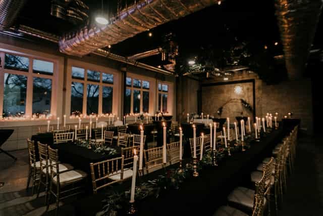 Elegant long table setup with candlelight for upscale dinners and corporate events.