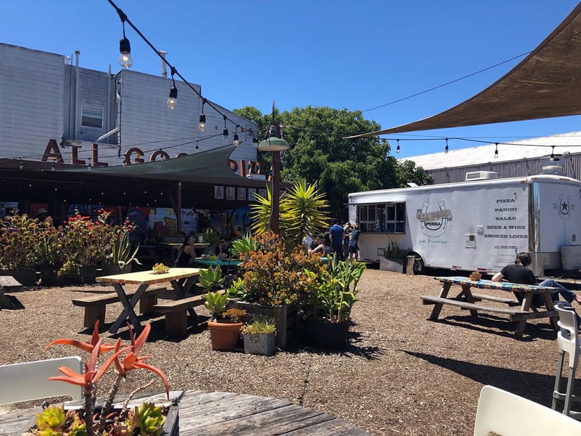 Beer Garden at All Good Pizza with picnic seating, perfect for casual events and gatherings.