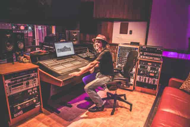 Professional sound engineer in advanced recording studio for high-quality audio production.