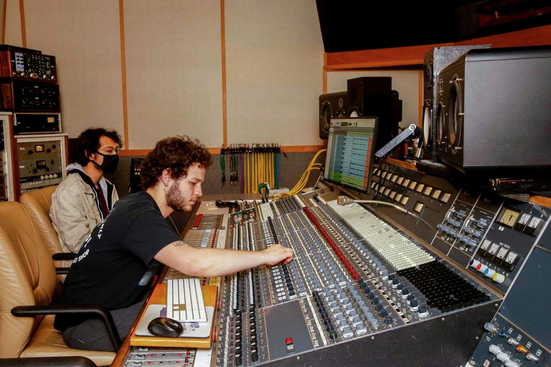 Professional audio mixing studio with technician ensuring optimal sound quality for events.