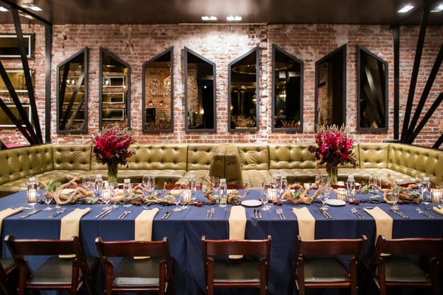 Elegant dining setup with navy linens for intimate restaurant buyout events.