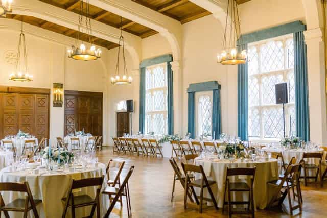 Elegant wedding venue with round tables and warm chandelier lighting in Berkeley City Club.