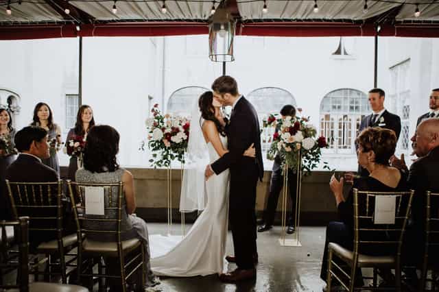 Elegant wedding ceremony at Second Floor Venue, Berkeley City Club with floral arrangements.