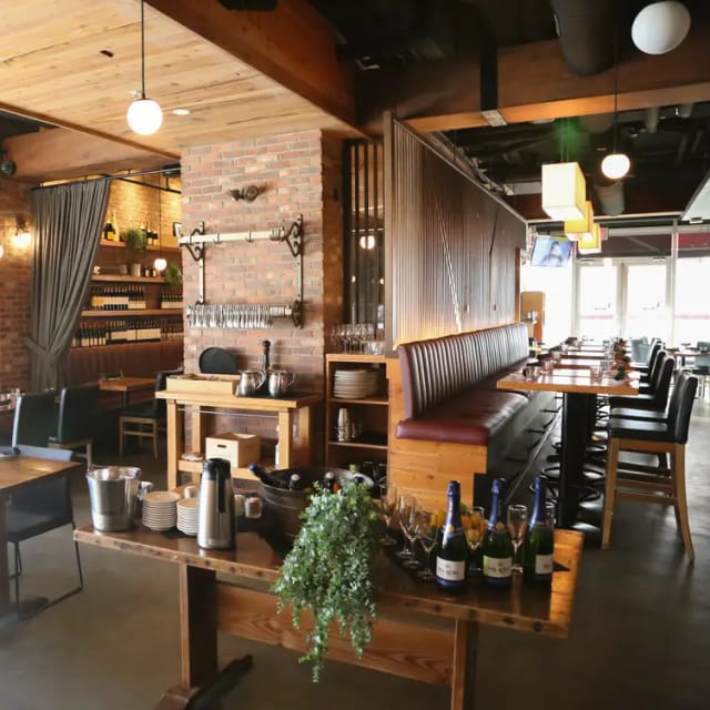 Main Dining Area at Flying Pig Bistro, cozy brick walls, ideal for networking events.